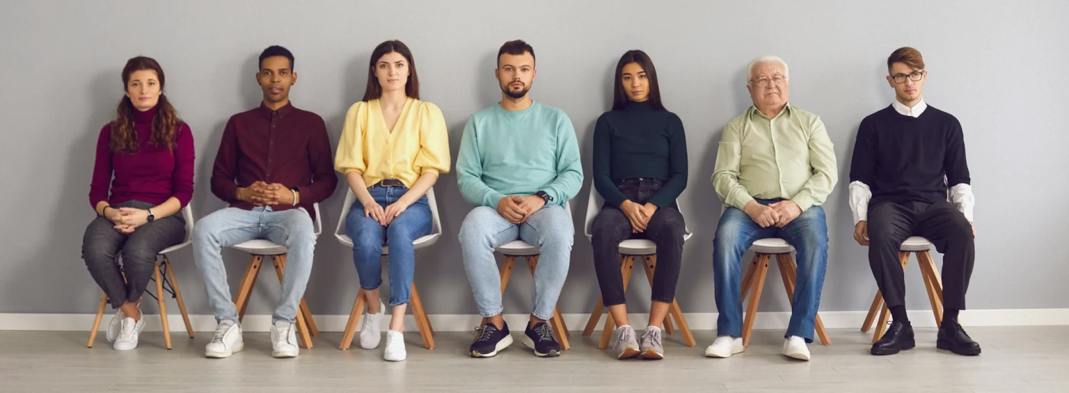 Diverse group of people seated together promoting a healthcare conversation guide for speaking with your GP