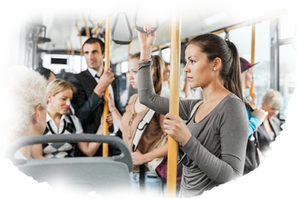Woman standing inside public transportation during daily commute holding overhead rail
